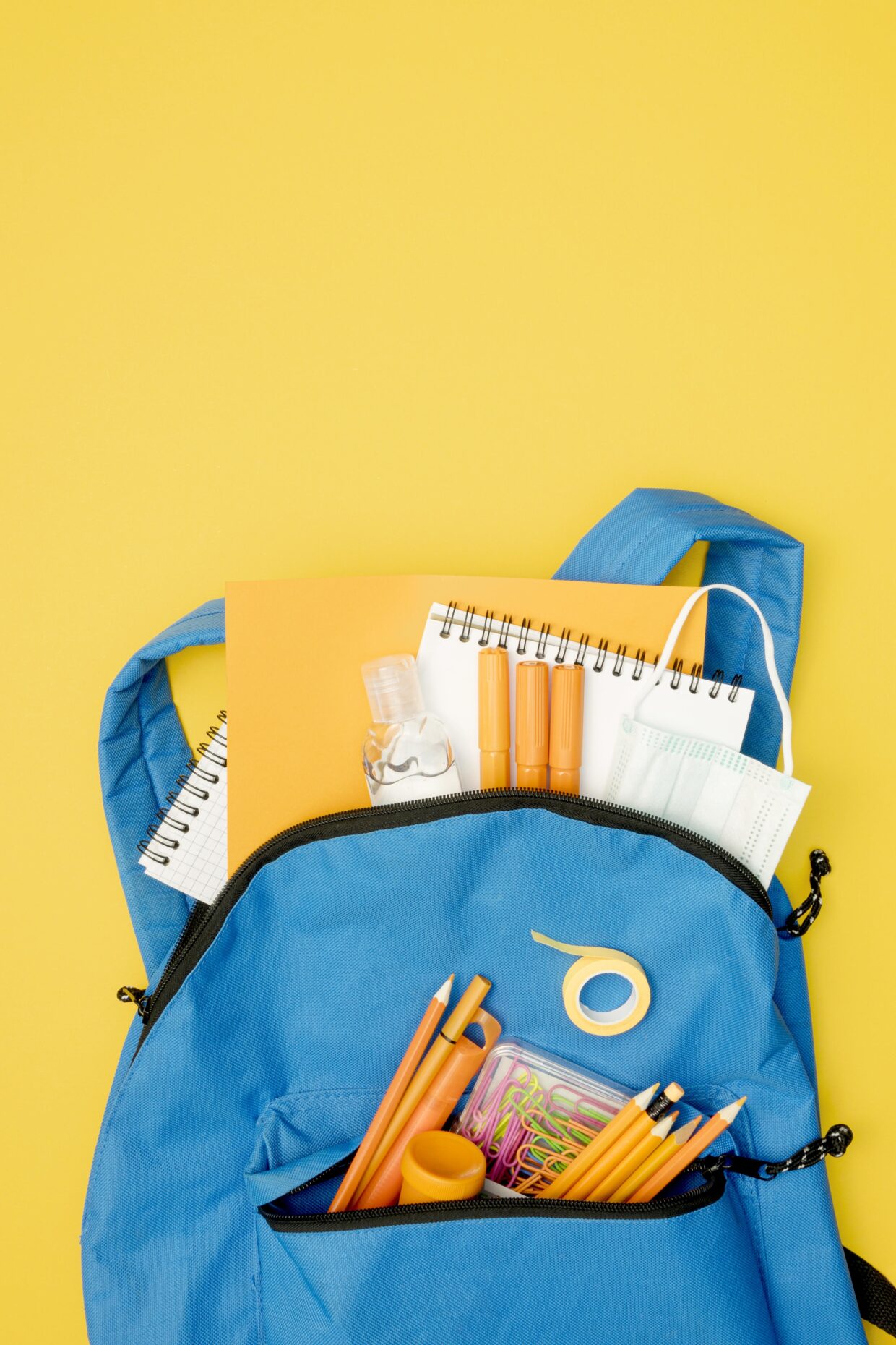 flat-lay-backpack-with-school-supplies
